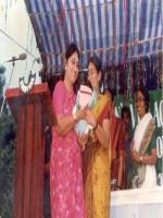 Minister Indra Kumari handing over baby